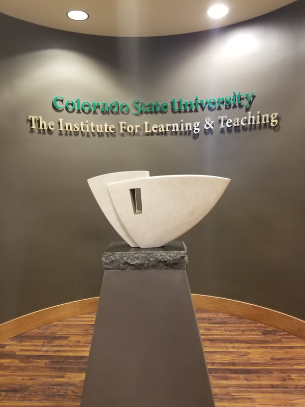 June 2018: Colorado State University has selected NSG Fellow Kathleen Caricof to create a sculpture honoring Alan Lamborn who retired from a 34-year career with CSU.

In designing the artwork, Caricof worked with the primary theme of the celebration of education, showing the importance of education as a foundation for the future.
​
The selected design, "Onward" is a sculpted stone representing the individual whose heart remains open to learning. A carved arrow points in the direction of growth.


NSG Public Art Placement 504
