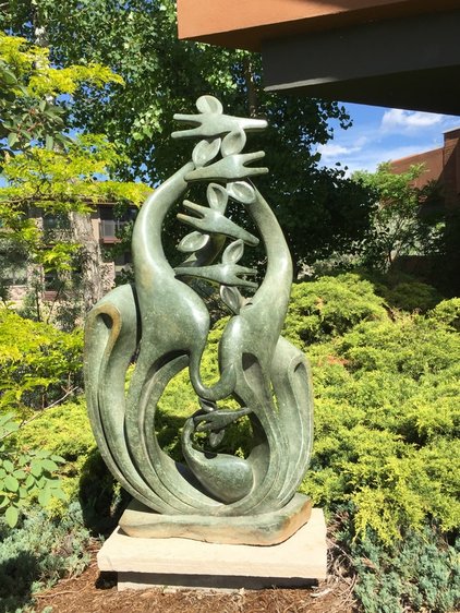 As the world watches the exciting arrival of the giraffe calf at Animal Adventure Park, we think fondly of one of the sculptures in the National Sculptors' Guild garden...  This piece symbolically depicts an unborn Giraffe calf in the protection of its mother's womb and family unit. 