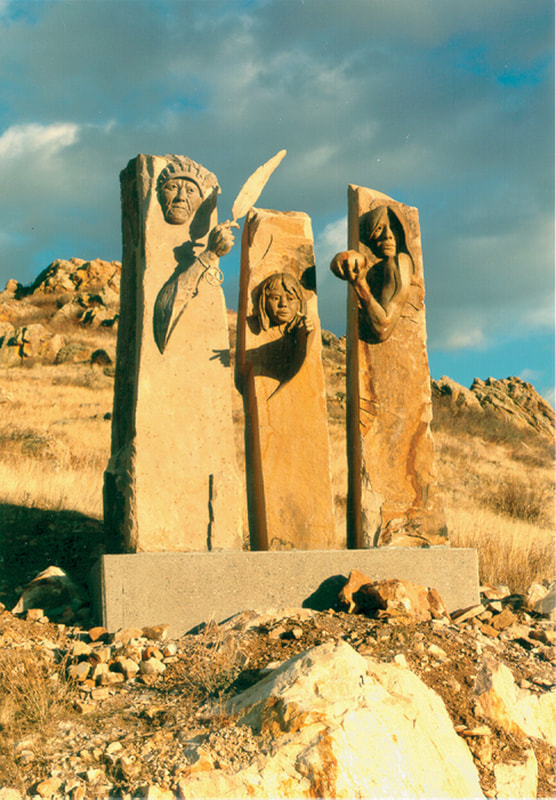 National Sculptors' Guild public art placement Denny Haskew Mariana Buttes 1993 Loveland, Colorado Bronze Sandstone Figurative Monolith; The Greeters by Denny Haskew and the National Sculptors' Guild placed at Mariana Buttes in Loveland, Colorado, 1993.  ​A series of columns depict the past, present and future through portraits of Native Americans; an elder holding a feather, a woman holding a piece of pottery, and a youth who extends their hand to the viewer.   A combination of Native sandstone and bronze, with bronze seemingly emerging from rough-hewn sandstone columns with a unique patina that matches the stone. This display of sculpture is very dramatic, and draws people in. 
