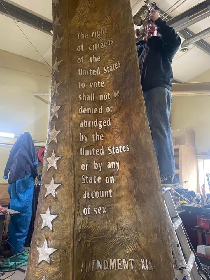 Things are really getting exciting now! The metal has been poured and chased and the patina is going on, Patina day fell on Susan B. Anthony's birthday!! We couldn't have picked a more appropriate date.   Below is Jane with the 12-ft bronze, prepping and applying the patina.  #VotesForWomen #RatificationFlag #PatinaDay