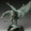 Wildlife bronze sculpture by SANDY SCOTT available at Columbine Gallery home of the National Sculptors' Guild Colorado's Largest Fine Art Source Specialists in Public Art A licensed pilot for more than thirty years, she feels her knowledge of aerodynamics has been helpful in achieving the illusion of movement in her bird sculpture. The Thomas Gilcrease Museum honored Sandy with a major retrospective exhibition in “Rendezvous ‘98”. Spirit of the Wild Things, a book about Sandy’s work was published the same year. Congratulations to Sandy for her recent accolades from the Briscoe Western Art Museum, honoring her with the Legacy Award. Sandy Scott received her formal art training at the Kansas City Art Institute and later worked as an animation background artist for the motion picture industry. She turned her attention to etchings and printmaking in the 1970’s and to sculpture in the 1980’s. Born in Dubuque, Iowa in 1943 and raised in Tulsa, Oklahoma, she is now headquartered in Lander, Wyoming near the foundry that casts her bronzes and she maintains studios on Lake of the Woods, Ontario, Canada and in the mountains of northern Colorado. Surrounded by mountains, lakes and streams, she is an avid outdoorswoman who loves to hunt and fish. In Canada her friends Dave and Michelle Beaushane who own Nestor Falls Fly-In Outposts frequently fly her and Trish (her long time friend who manages the business end of things) to remote lakes and portages north of Kenora, Ontario. She has made 16 trips to Alaska and has been to Europe, Russia, China and South America to visit the world’s great museums. She believes wildlife artists should be in the field to accurately present their subject to the viewer. Her work is authentic. She has experienced and lived what she depicts.