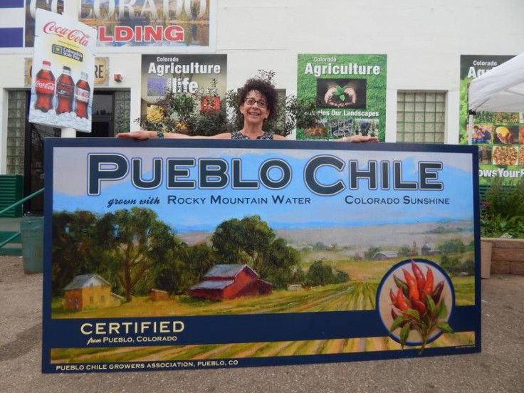 Teresa Vito with the Pueblo Chile Growers Association label she painted. now becoming a colorado license plate. Vito has been a full time oil painter since 1992. She currently lives in Pueblo, Colorado. Vito has won numerous national and regional awards including an Award of Excellence, Best Portrait and Best Still Life Awards from Oil Painters of America. She also received the Best of Show award from the Artists of Colorado Exhibition held at the Colorado History Museum.