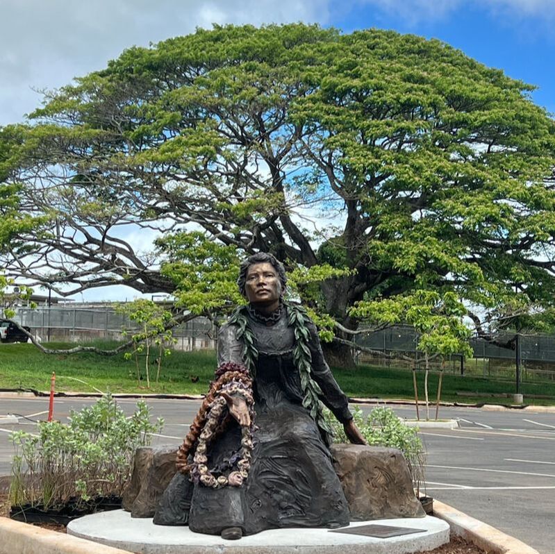 ​A universal figure representative of a tūtū with outstretched arm draped in colorful leis as an offering to her island in an expression of aloha, compassion, gratitude, and acceptance.  The benevolent gesture of Forgiveness is symbolic of the traditional Hawaiian customs of aloha and ho’okipa, the Native Hawaiian values of hospitality and giving. Native Hawaiians have always believed in selflessly extending themselves to others, whether they had close ties with them or not. Housing this sentiment at the Women’s Community Correctional Center is fitting as a place where women can individually grow and contribute to the greater community. The more one cares for the world, the greater the world will sustain and provide.  May this artwork provide a positive space for the women, workers, and visitors. A place one can sit and reflect, seek guidance, see themselves in her, or someone they love. -Jane DeDecker and the National Sculptors' Guild  Special thanks to Ultimate Innovations for hardscape, landscape and installation services. Madd Castings and DeDecker Studio who cast and finished the bronze sculpture, Shipper's Supply for getting the artwork to Hawai'i safely. And to Kamakani and Alex from the Hawai'i State Foundation on Culture and the Arts and the WCCC committee for collaborating on the placement. We hope it makes all of Hawai'i proud.